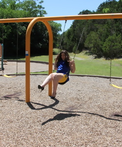 Mature with naked pussy under tight skirt riding on a swing